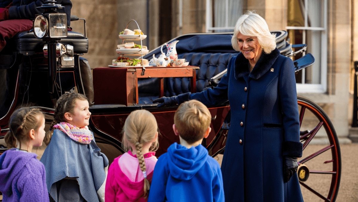 Queen greeting guests at a tea in her London home