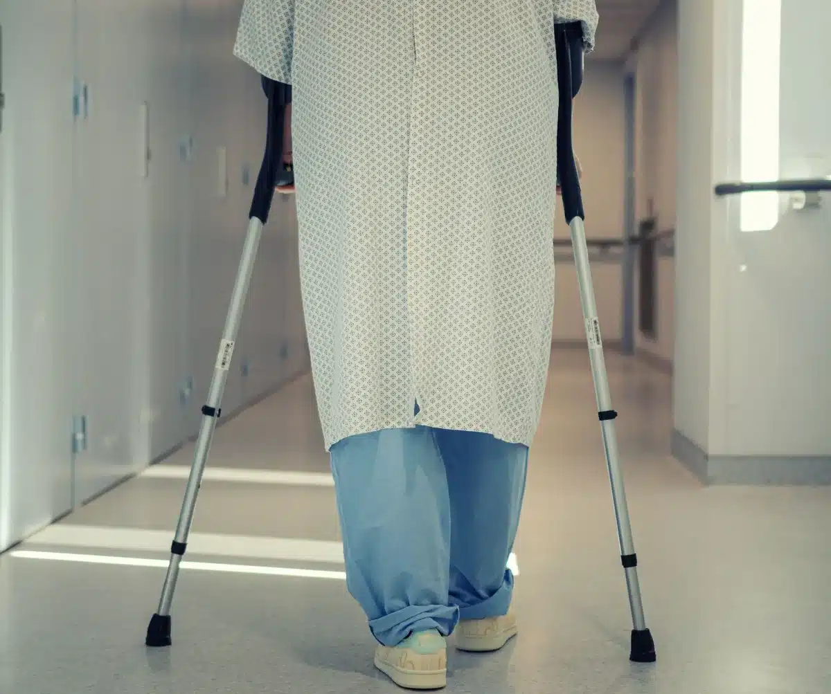 A person receiving medical care and rehabilitation treatment in a clinical setting.
