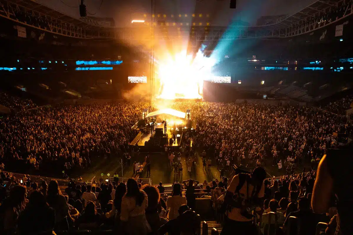 Interior of a large modern concert arena with seating and stage setup ready for performances.