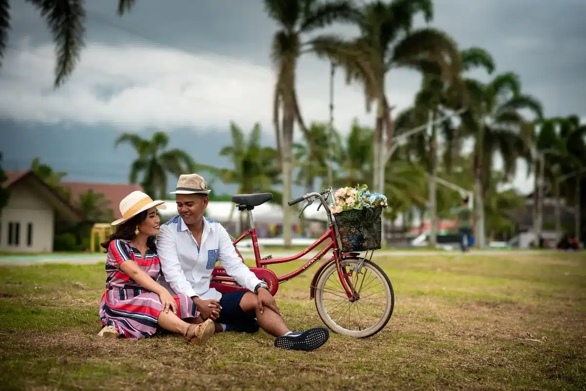 Two people enjoying a relaxed outdoor moment in a park setting