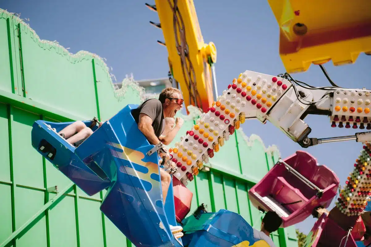 Families enjoying rides and attractions at a theme park