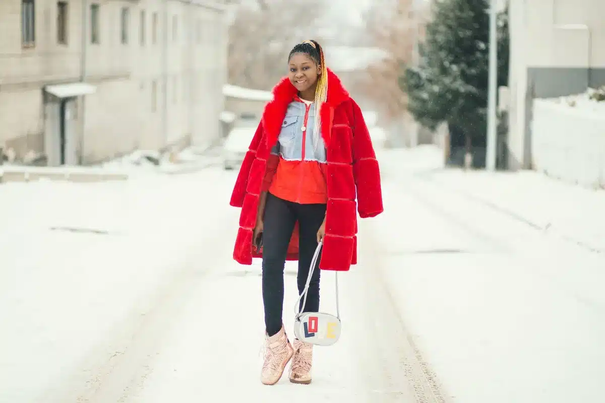 Stylish person in statement coat and tailored boots at an event