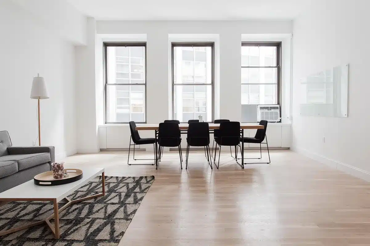 Bright living room table with architectural sketches, coffee cup and a toy in daylight