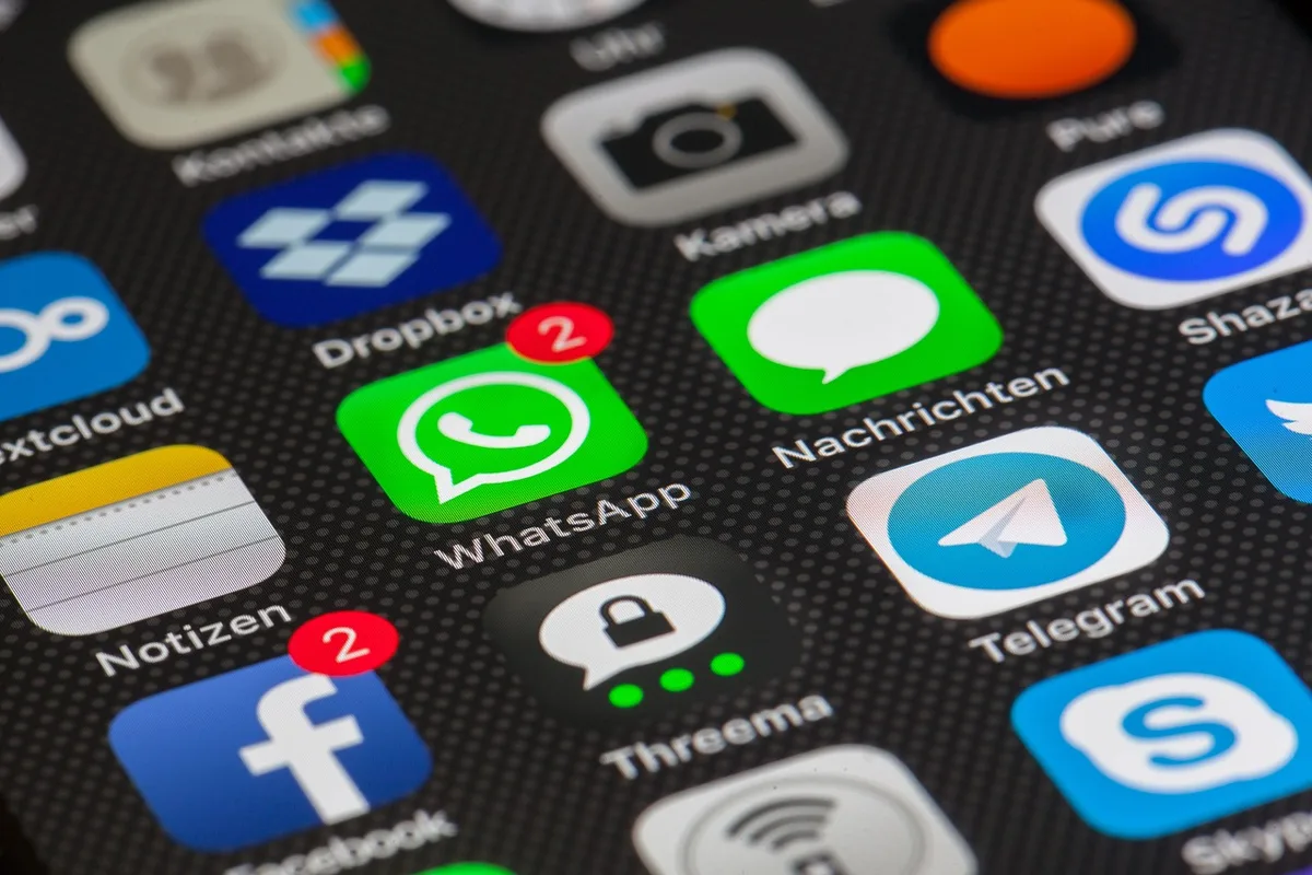 Close-up of smartphone screen showing mixed social media comments and reactions