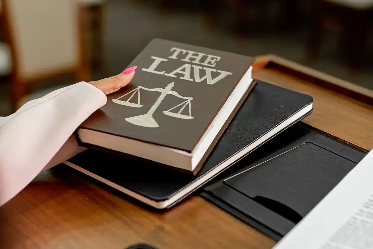 Close-up of a gavel and legal papers on a bright table