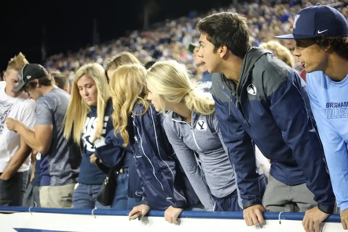 Crowded stadium stands and a blurred sideline capturing game-day urgency