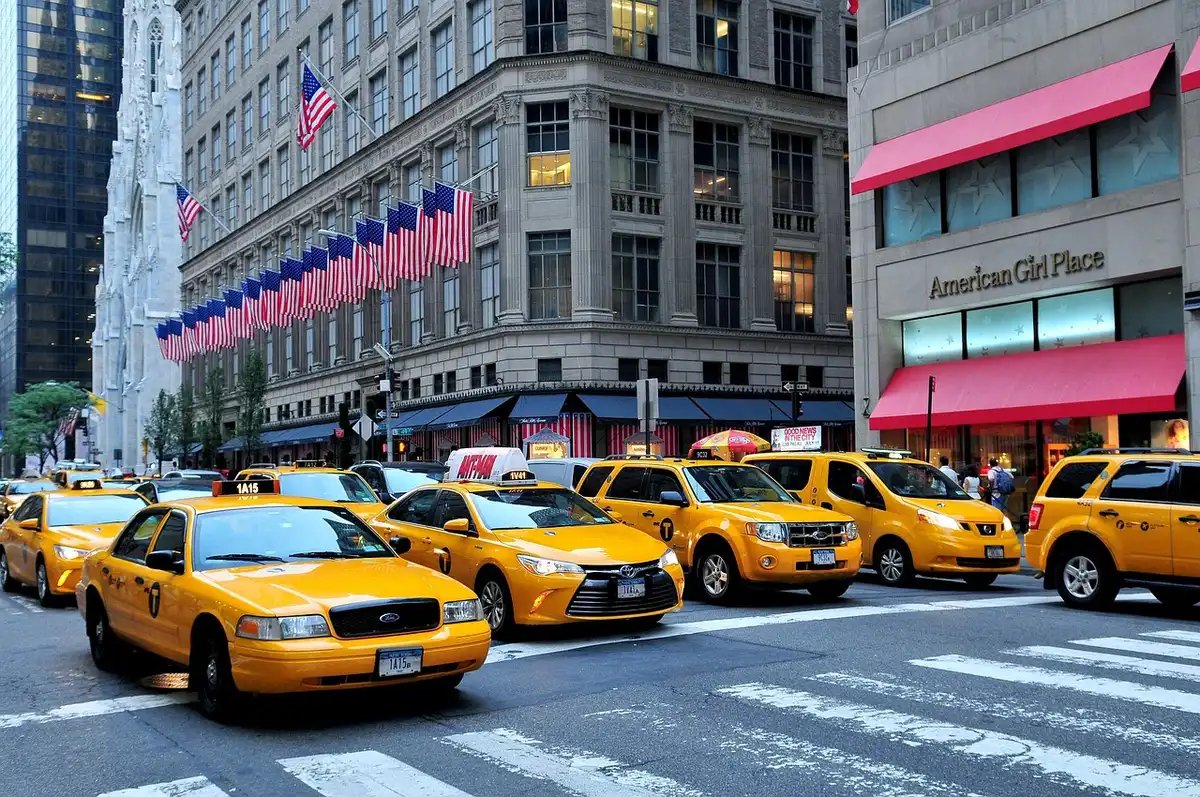 Daytime New York street with pedestrians showcasing street-style outfits