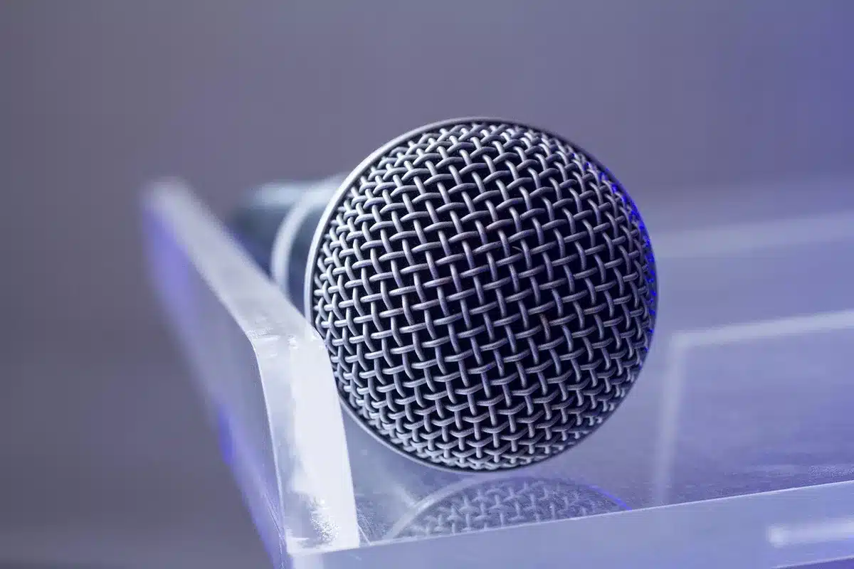 Empty TV studio chairs and a microphone on a brightly lit set