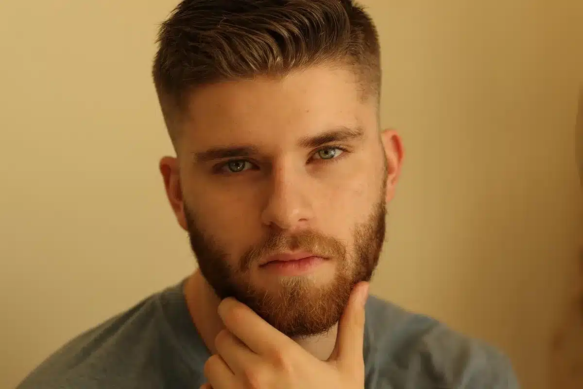 Hands holding a smartphone showing a short social video on a bright background