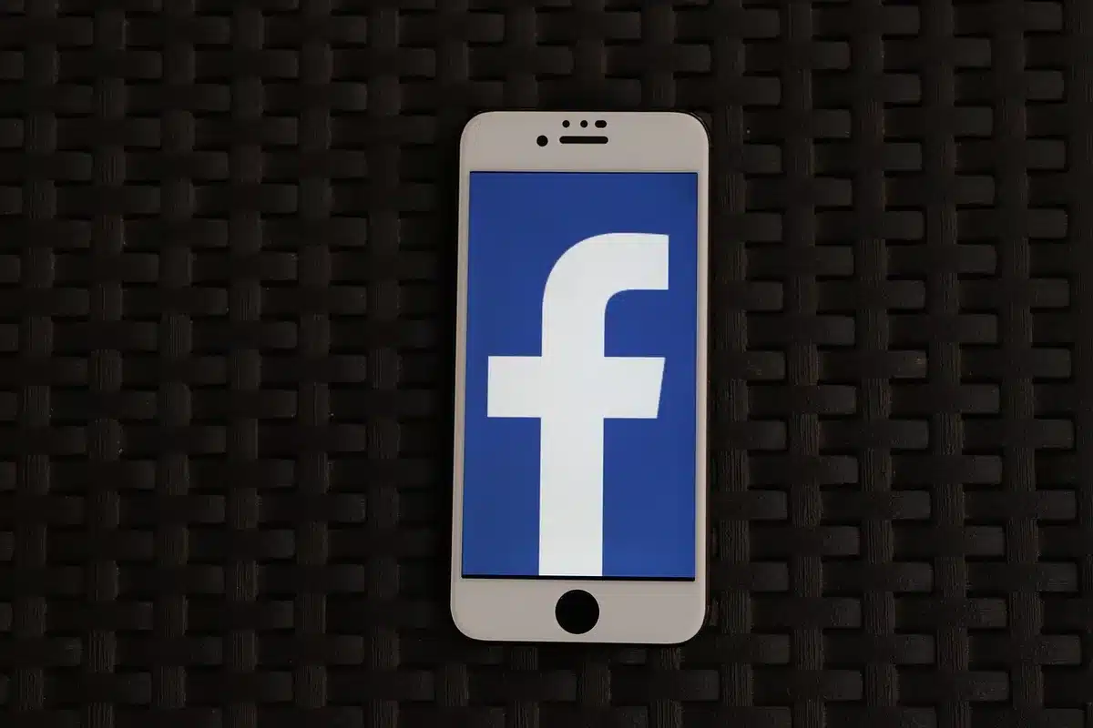Hands holding a smartphone showing social media reactions