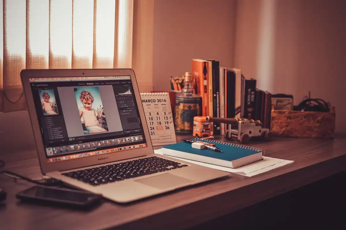 Editor working at a bright desk with an article open on screen