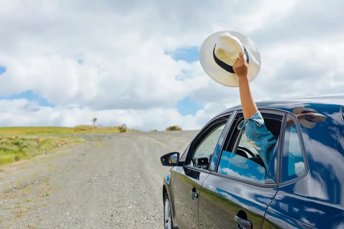 A daytime roadside scene with a small group gathering, hinting at community and culture