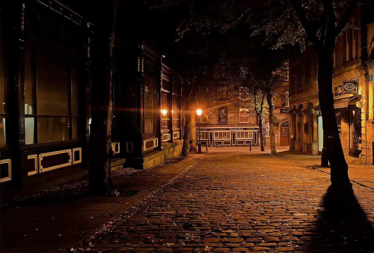 Sunlit cobblestone street in Rome with elegant venue entrance