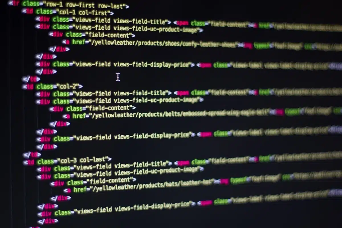Developer laptop with code editor showing lazy-loading and async scripts