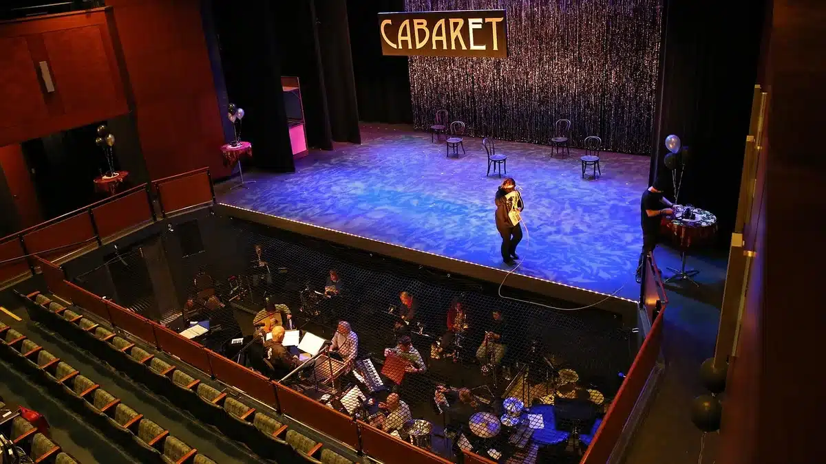 Actors' scripts and a rehearsal notebook on a theatre stage